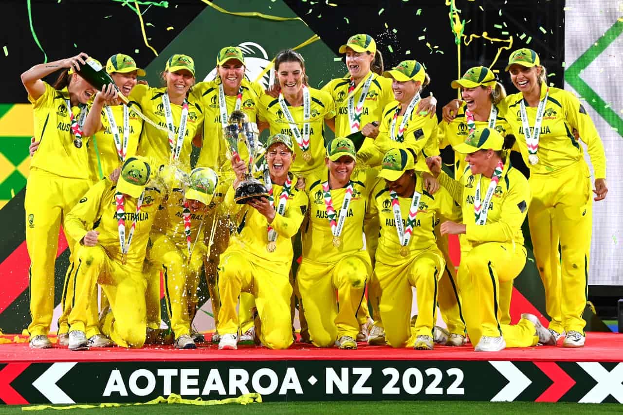 Australia celebrate with the trophy after winning the 2022 ICC Women's Cricket World Cup Final