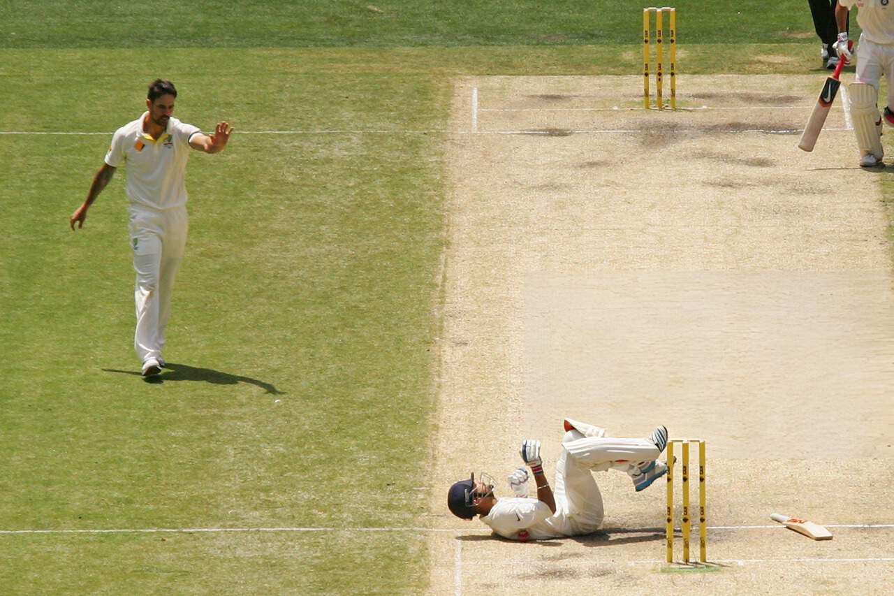 Virat Kohli falls to the ground after being hit from bowler Mitchell Johnson